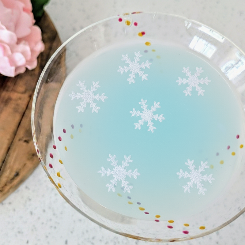 Pre-cut edible wafer paper snowflake drink toppers on a light background