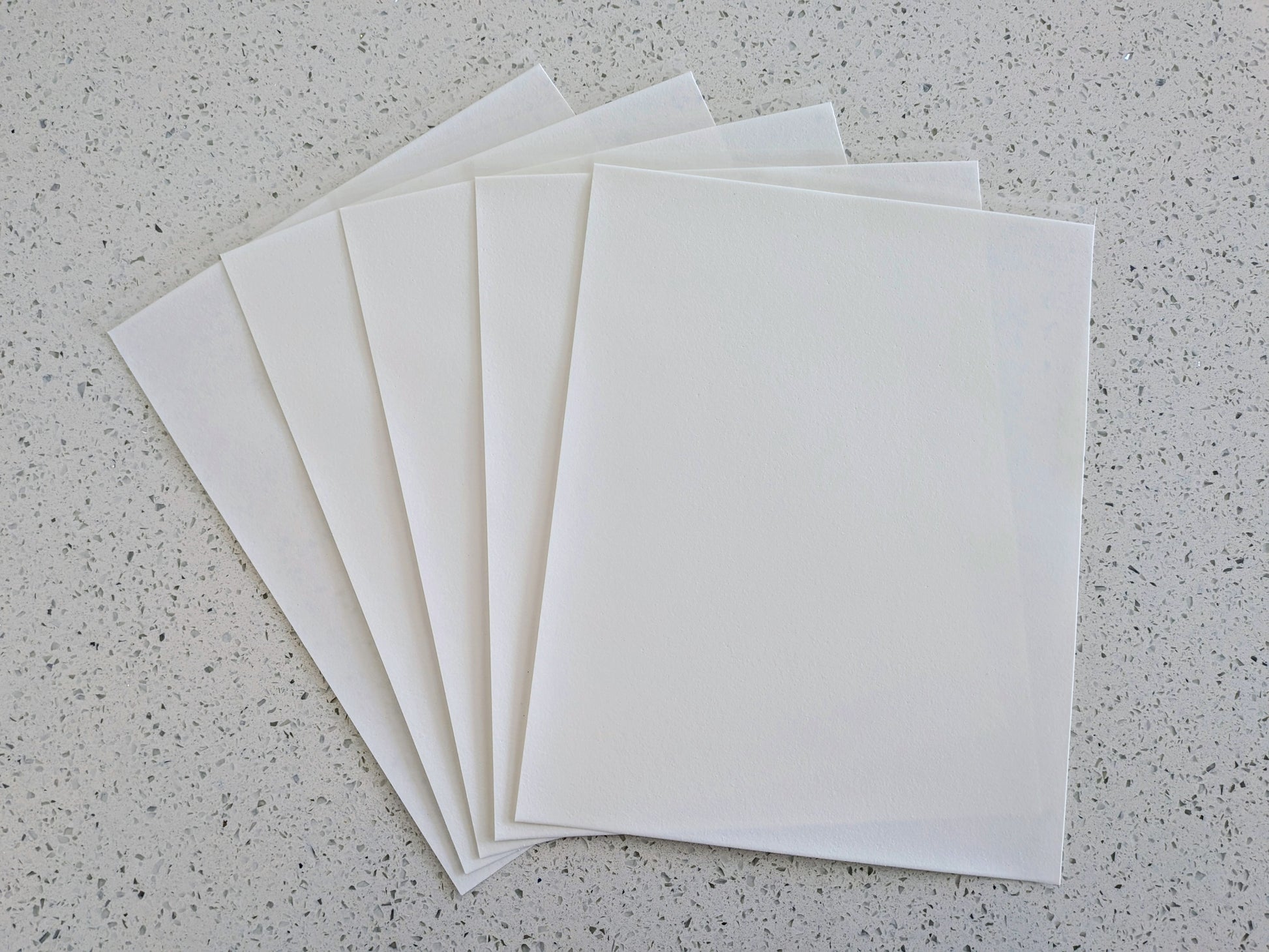 Edible icing paper sheets on a gray speckled surface