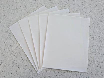 Edible icing paper sheets on a gray speckled surface
