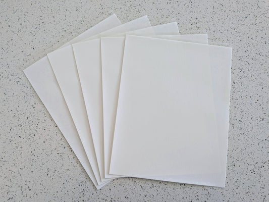 Edible icing paper sheets on a gray speckled surface