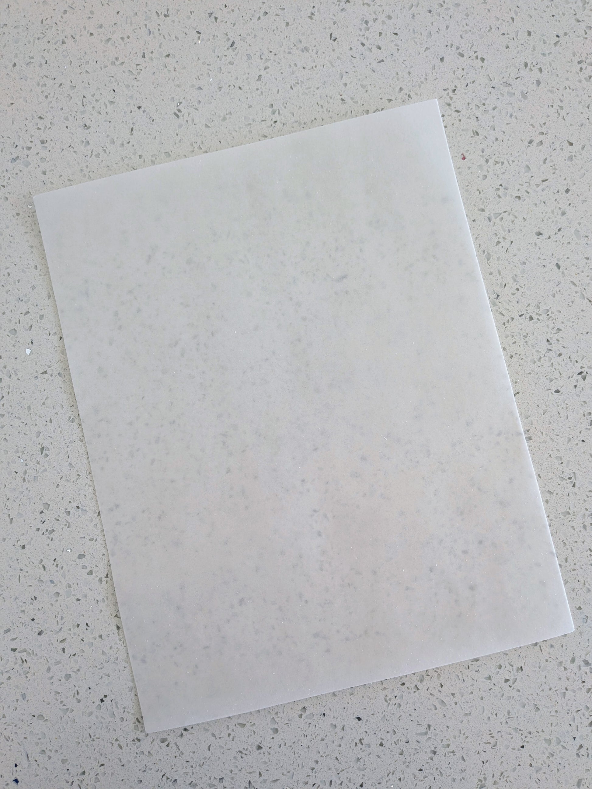 Edible wafer paper on a speckled gray surface
