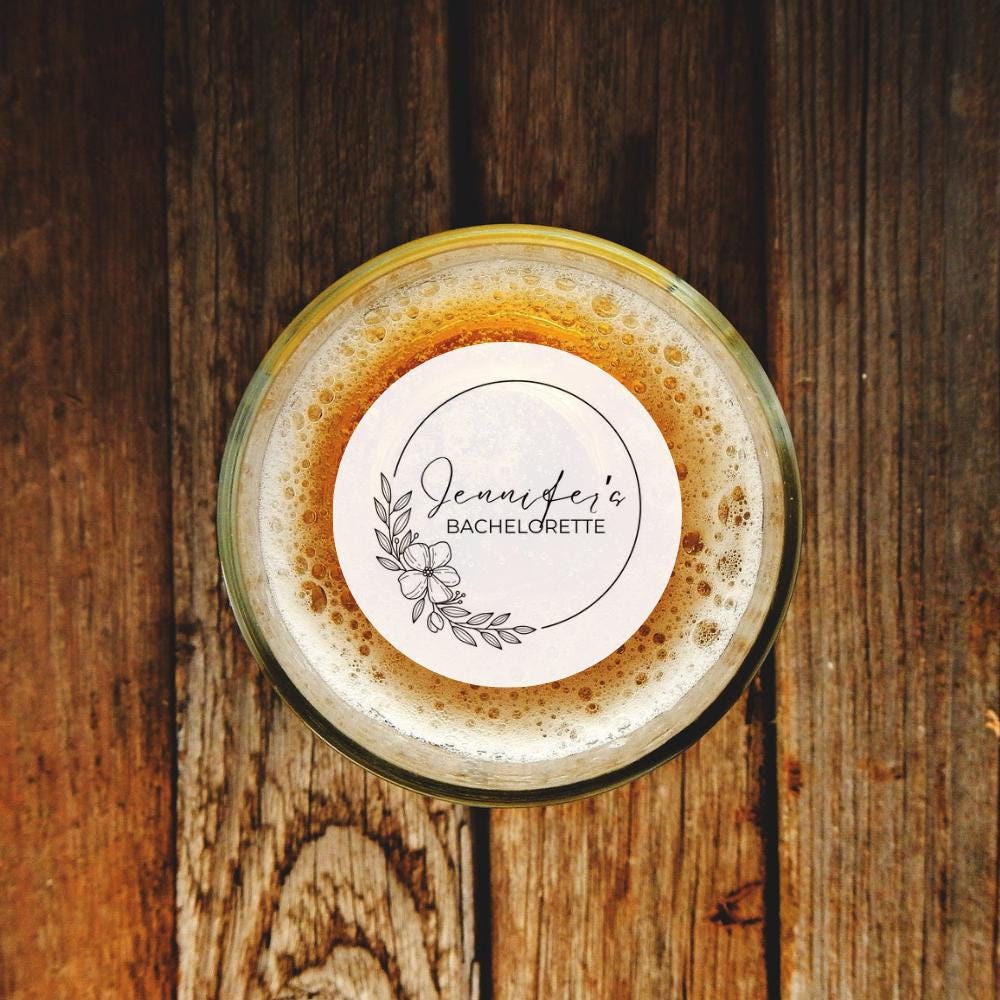 Glass of beer with a drink topper on a wooden surface