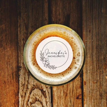 Glass of beer with a drink topper on a wooden surface