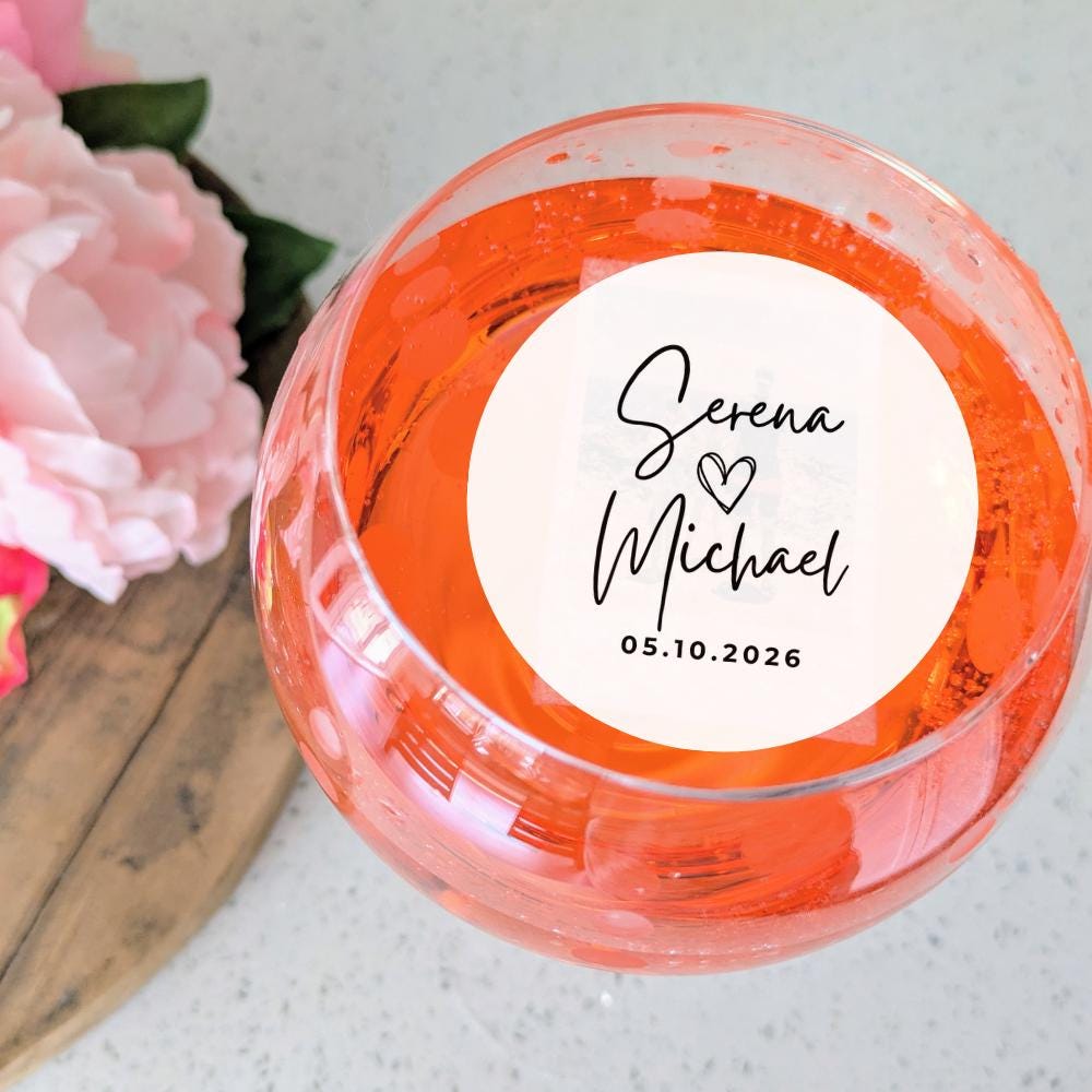 Personalized wedding cocktail garnish with names and date on a white background